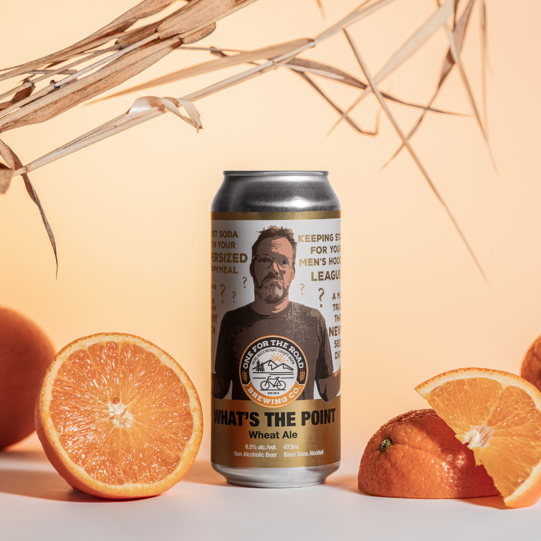 What's The Point Wheat Ale Can in a peach coloured settingsurrounded by wheat and citrus fruits to represent the flavour profiles